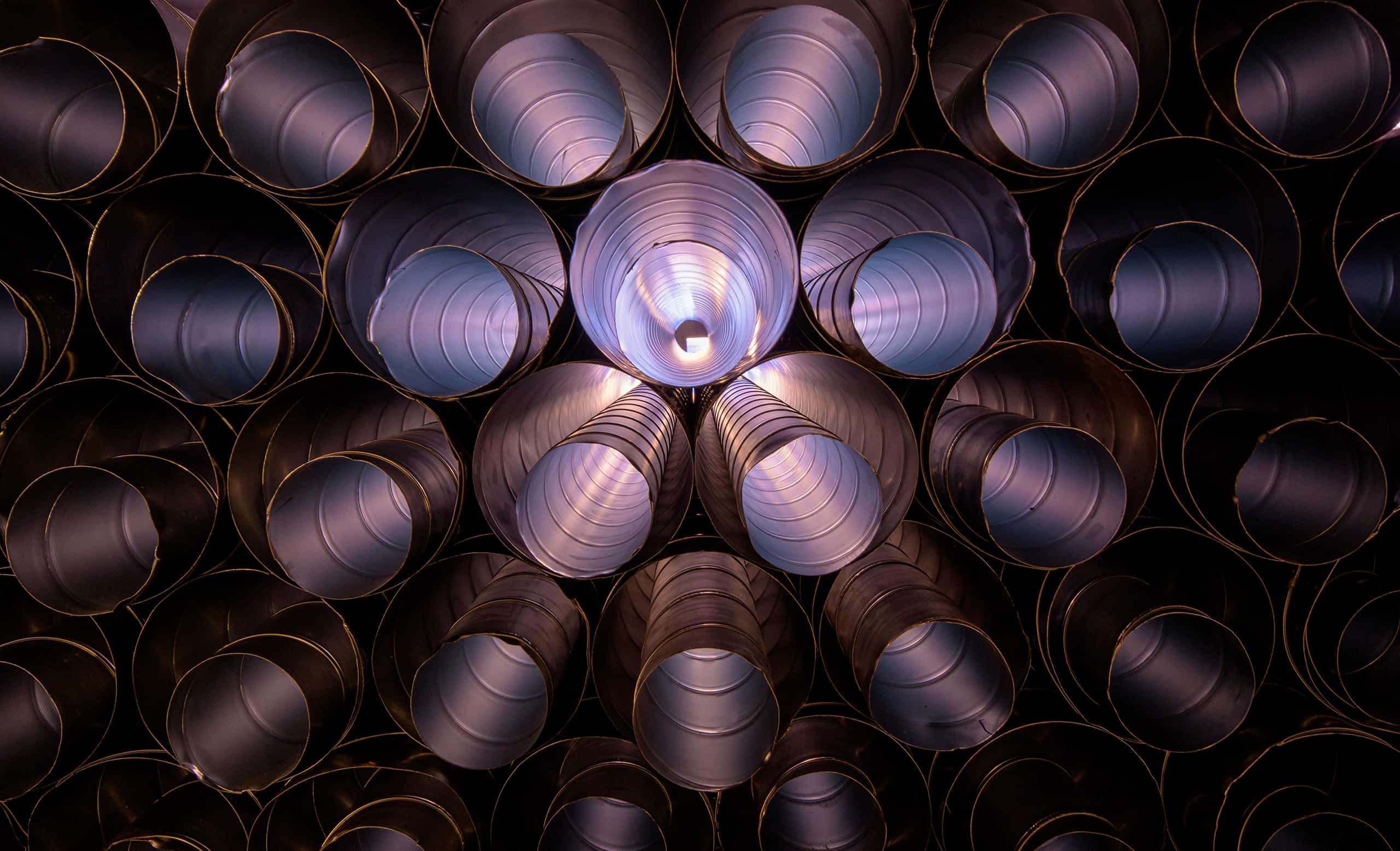 A large collection of round ducts stacked on top of eachother