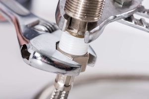 A wrench attaching a hoze to a nozzle