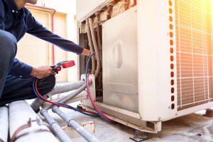 A technician diagnosing a faulty HVAC system