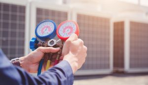 An HVAC technician using diagnostic equipment